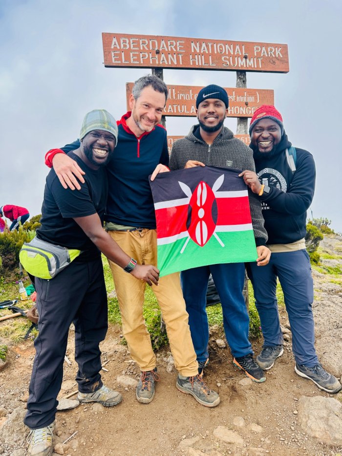 Haron Owalo with friends at the Elephant Hill summit, a climb he led
