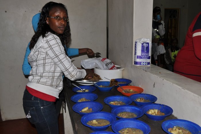 Haron Owalo helping serve meals at a community feeding program